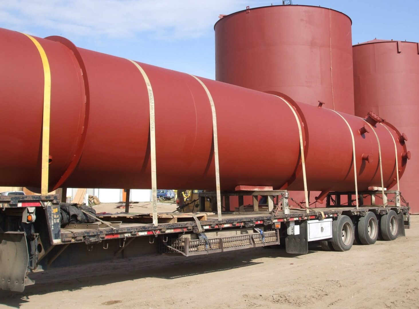 A large red tank on the back of a truck.